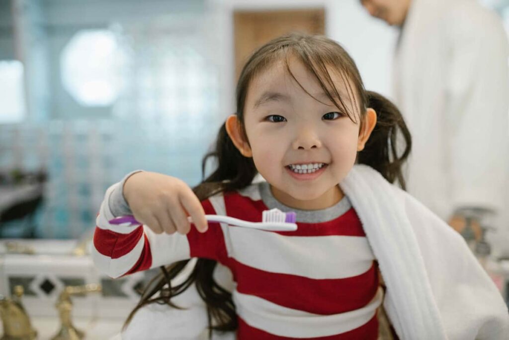 Girl with Toothbrush | Bloor Smile Dental